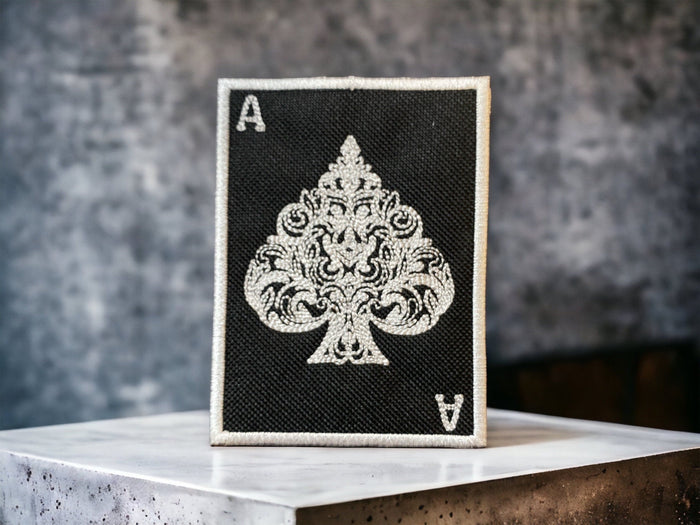 Ace of Spades embroidered patch used as the cover image for cards, symbols, and badges.