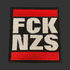 Embroidered patch with 'FCCK NZS' text on a textured surface