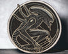 Embroidered patch of a dragon design on a textured surface